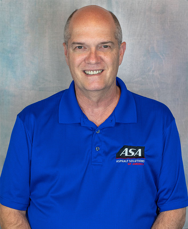 Brad Hicks in a blue shirt showcasing commercial asphalt solutions
